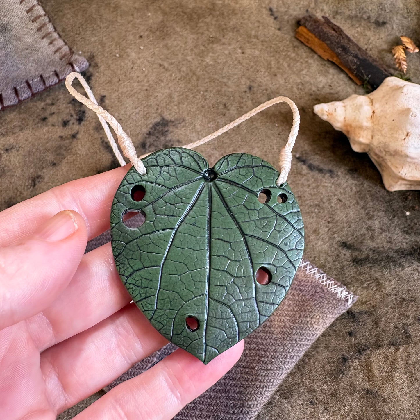 Kawakawa Necklace Large 6cm. On cream cord